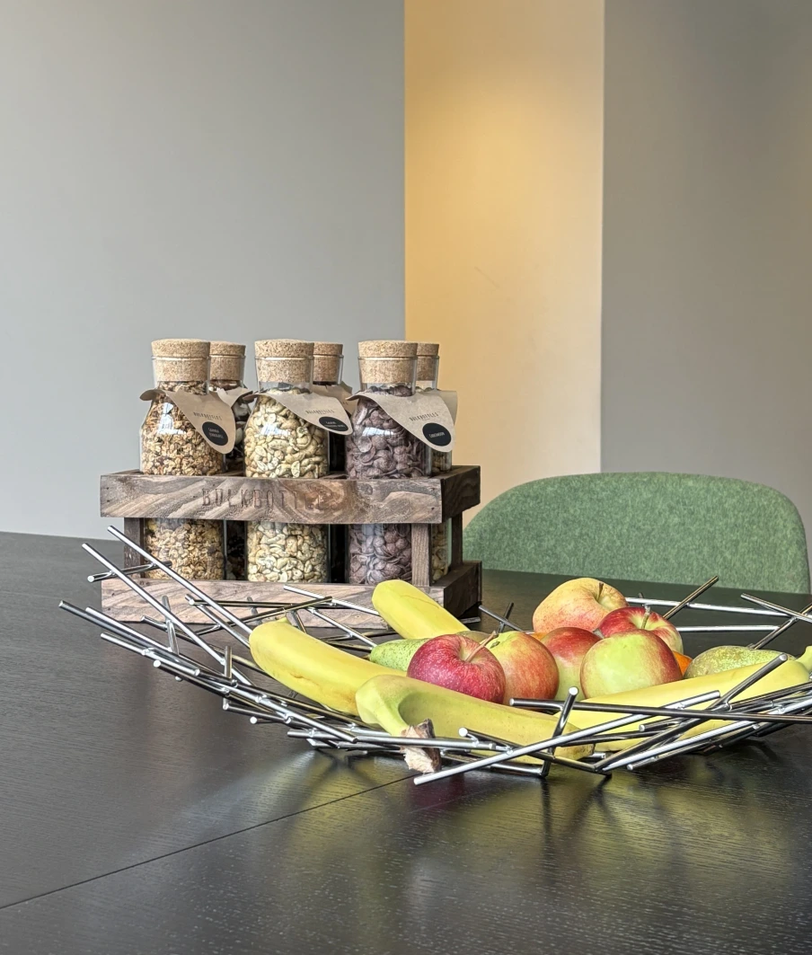 bouteilles en verre consignées contenant des fruits secs et corbeille de fruits frais